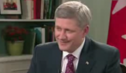 Harper giving a smug grin after (barely) answering questions about marijuana which dominated YouTube's question/answer poll.